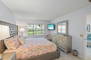 King sized comfortable bed, dresser and TV in the master bedroom