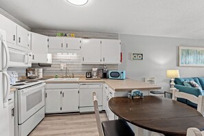 Full Kitchen with Microwave, toaster, coffee maker, cooking utensils, and more.