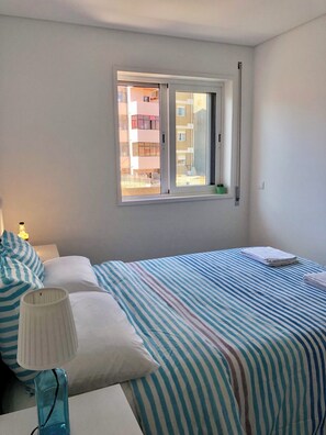 the bedroom w/ double bed and wardrobe