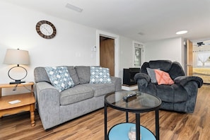 Comfy living area with smart TV and toys for the kids.