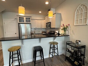 Designer kitchen and eating area, including coffee/wine bar and granite counters