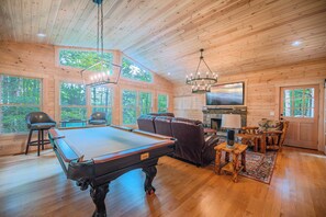 Pool table/game room in living area with beautiful natural light