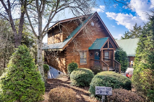Embrace the tranquility of nature with this charming house featuring a lush green roof, nestled among the whispering trees