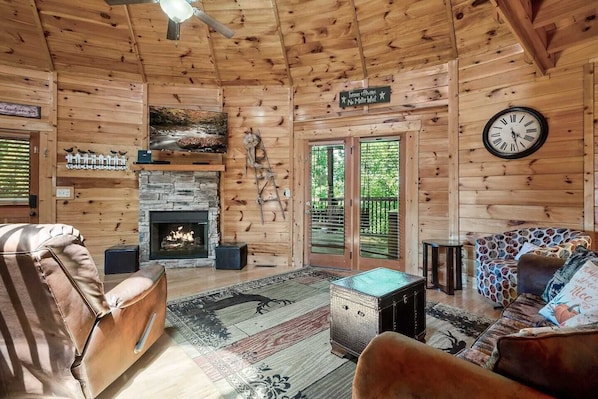 Immerse yourself in the cozy vibes of this living room, where every piece of furniture tells a story. The crackling fireplace adds warmth and charm.