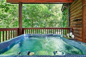 Immerse yourself in luxury with this stunning hot tub perched on a wooden deck, offering the perfect blend of relaxation and nature.