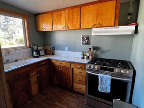 Well equipped kitchen with gas stove.  