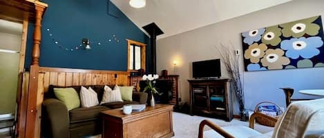 Living room with wood stove and smart TV.
