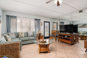 Living room with back door to our private balcony which looks over the pool and Jacuzzi