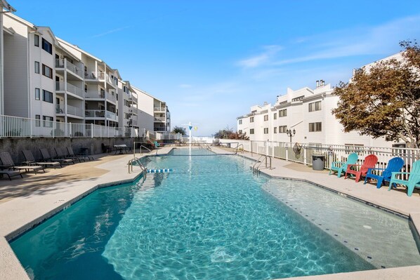 The Pool is surrounded by plenty of lounge chairs, offering a perfect spot to relax and enjoy the sun. The pool is conveniently located near the building, making it easy to take a refreshing dip anytime.