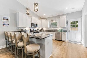 The kitchen island is the ideal spot for meal prep, casual dining, and socializing with friends and family.