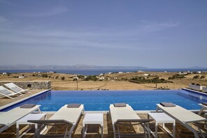 Relax and unwind at the pool overlooking the Aegean Sea.