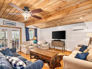 Living room with plenty of seating leads onto screened porch.