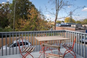 Balcony with seating and views of the neighborhood.