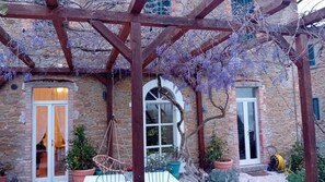 In the Spring, the pergola is covered in wisteria