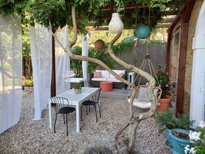 Lounge seating, table for 6, two swinging chairs, solar globes and curtains