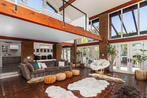 The Sky Lounge: With floor-to-ceiling windows, this living room feels like a nest in the clouds. The plush, oversized couch invites you to sink in and enjoy panoramic views of the cityscape or natural surroundings. #PhoenixParadise