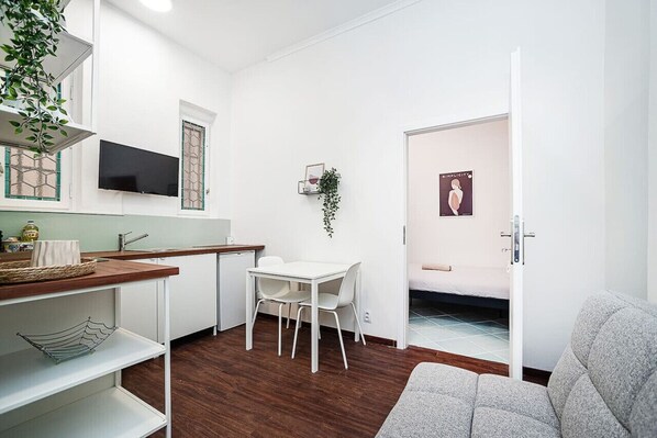 kitchen with seating area and door to the bedroom