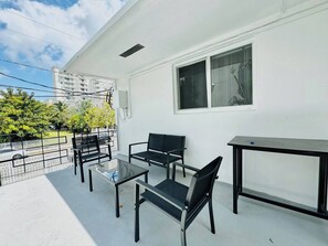 Welcome to the outside of the apartment, the patio, an outdoor oasis where you can enjoy a serene and charming atmosphere