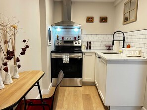 Cook up a storm in our bright kitchen with crisp white tiles.