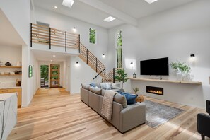Living room with 75" TV and Fireplace