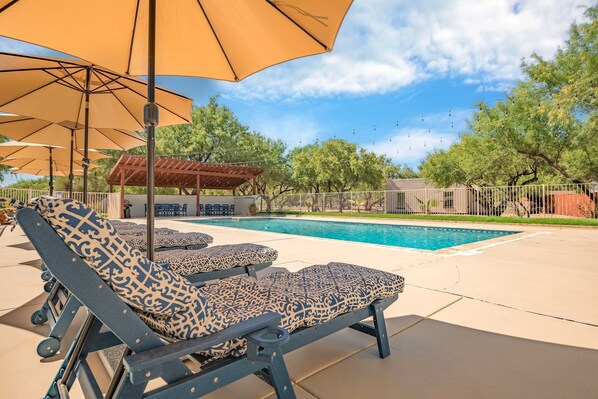 Shade umbrellas at the resort pool for sunny days