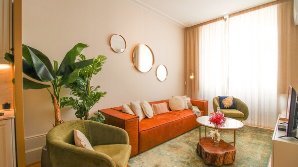 Bright living area with a sofa and a flat screen TV. #living #tv
