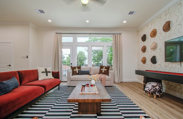 Modern wester interior for the living room with 2 couches and shuffleboard & TV