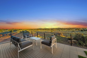 Outdoor rooftop terrace with seating on deck and turf tiles, perfect for stretching, working out, and yogo in the beautiful mornings
