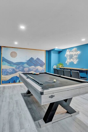 Game Room with Pool table, live edge bar ledge, Mural, and neon sign
