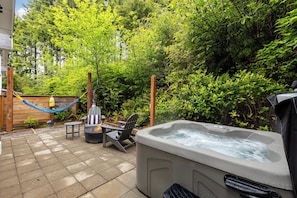 Private wooded patio with hot tub, gas firepit and hammock