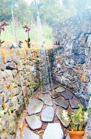 Most guests RAVE that they love the outdoor shower experience! You can enjoy spa vibes of being surrounded by forest and lava rock walls.