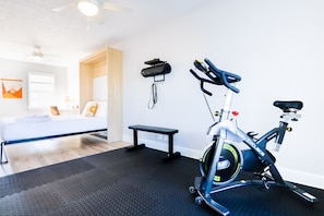 Second bedroom is equipped with a dedicated workspace, queen Murphy Bed, and exercise space