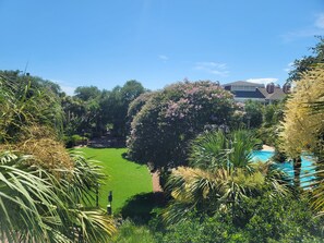 View of the lush grounds and resort pool from the private balcony