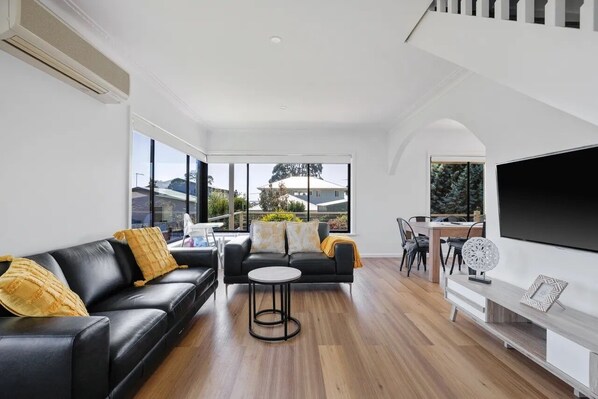 Upstairs living area with TV and seating area