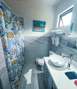 serene, stylish bathroom located on the upper level.