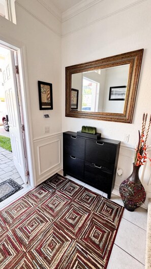 Upon entering the property, you'll find a cozy foyer leading to both the suite at the end of the hall and the garage, which includes the laundry room.