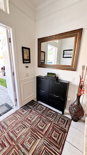 Upon entering the property, you'll find a cozy foyer leading to both the suite at the end of the hall and the garage, which includes the laundry room.