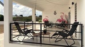 A spacious terrace with ample seating to  relax and enjoy the wind and pool