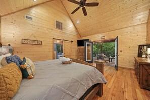 King sized bed in main bedroom offers direct access to the hot tub!