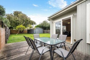 A sunny deck overlooking the backyard provides a relaxing space to enjoy an outdoor lunch or a glass of wine while you soak up the sea breezes. 
