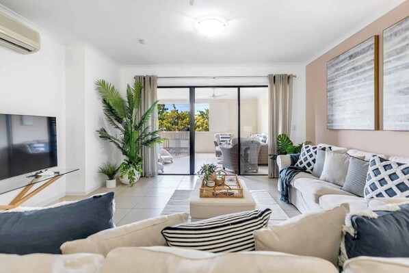 The light-filled living area includes two sofas to settle in with a movie, while ceiling fans and split system air conditioning ensure year-round comfort. 
