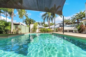 Refresh after a day of sightseeing with a dip in the shared pool, complete with outdoor seating and a grassy lawn area. 
