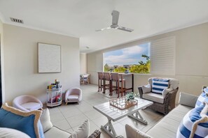 A generous balcony is furnished with a sofa, armchairs and additional seating, providing the perfect setting for relaxed entertaining. 
