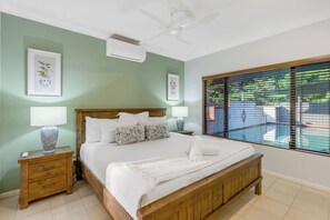 The light and spacious primary bedroom includes a king-size bed with views overlooking the pool, while an ensuite offers privacy and ease. 
