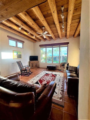 Living room with tall windows and ceiling fan