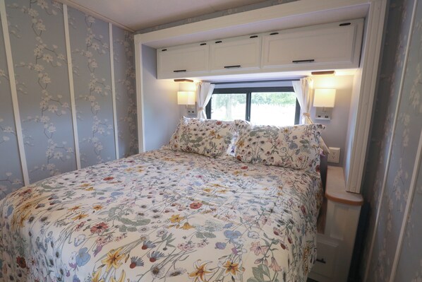 Master Bedroom is very cozy with USB chargers in the lights and lots of storage.