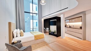 Elegant T1 apartment in Savoy Insular Residence, Funchal. Features a spacious studio layout with a cozy bed, main TV, and chic decor. Perfect for luxurious living. #studio #luxury #AC