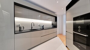 This apartment features a modern kitchen with top-of-the-line appliances, sleek countertops, and stylish cabinetry, perfect for culinary enthusiasts. #fullyequipped #modern #cookings