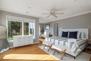 Rest and recharge in this beautiful primary suite with expansive lake view
