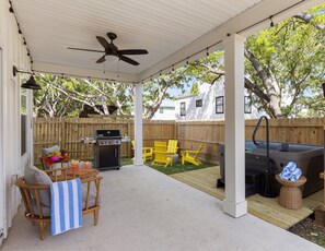 Backyard with hot tub, fire pit, and grill